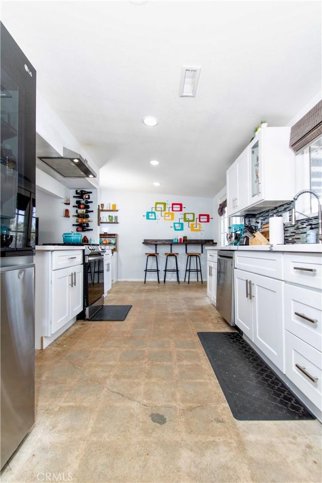 5536 Cahuilla Ave Unit 29, Palms, CA 92277 - kitchen with appliances with stainless steel finishes, white cabinetry, concrete flooring, a sink, and recessed lighting