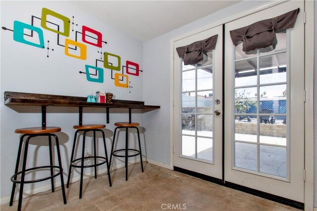 5536 Cahuilla Ave Unit 29, Palms, CA 92277 - doorway to outside with concrete flooring, baseboards, and french doors