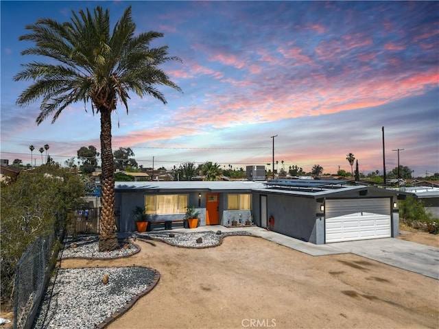 5536 Cahuilla Ave Unit 29, Palms, CA 92277 - mid-century modern home featuring an attached garage, driveway, and solar panels