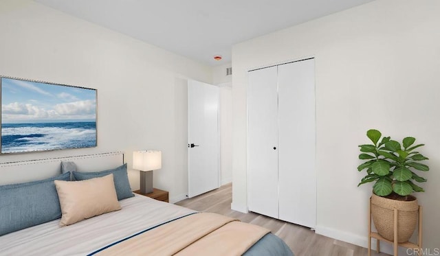 1524 Bridgeview Dr, San Diego, CA 92105 - bedroom with light wood-type flooring, a closet, and baseboards