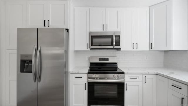 1524 Bridgeview Dr, San Diego, CA 92105 - kitchen featuring stainless steel appliances, white cabinets, backsplash, and light stone countertops