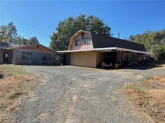 9275 Sheep Ranch Rd, Mountain Ranch, CA 95246 - view of property exterior with a gambrel roof and gravel driveway