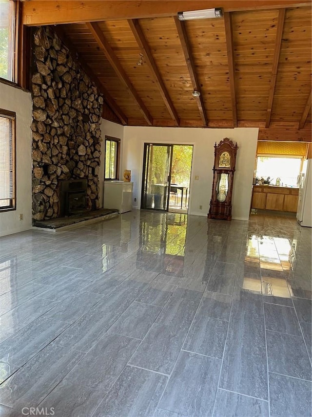 9275 Sheep Ranch Rd, Mountain Ranch, CA 95246 - unfurnished living room with wooden ceiling with exposed beams, high vaulted ceiling, and a wood stove