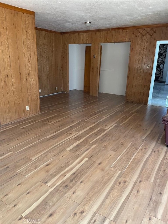 9275 Sheep Ranch Rd, Mountain Ranch, CA 95246 - unfurnished room with wood-type flooring, wood walls, and a textured ceiling