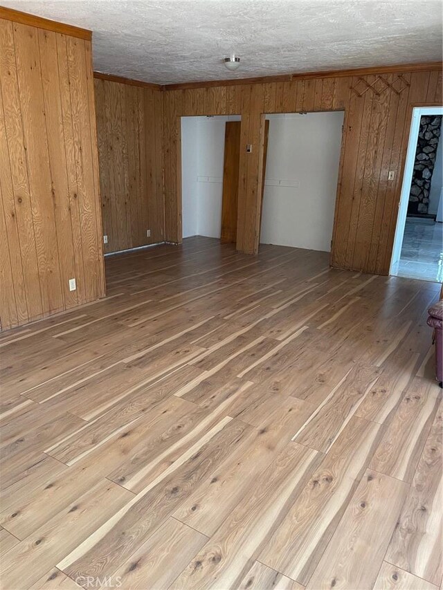 9275 Sheep Ranch Rd, Mountain Ranch, CA 95246 - unfurnished room featuring wood-type flooring, wooden walls, and a textured ceiling
