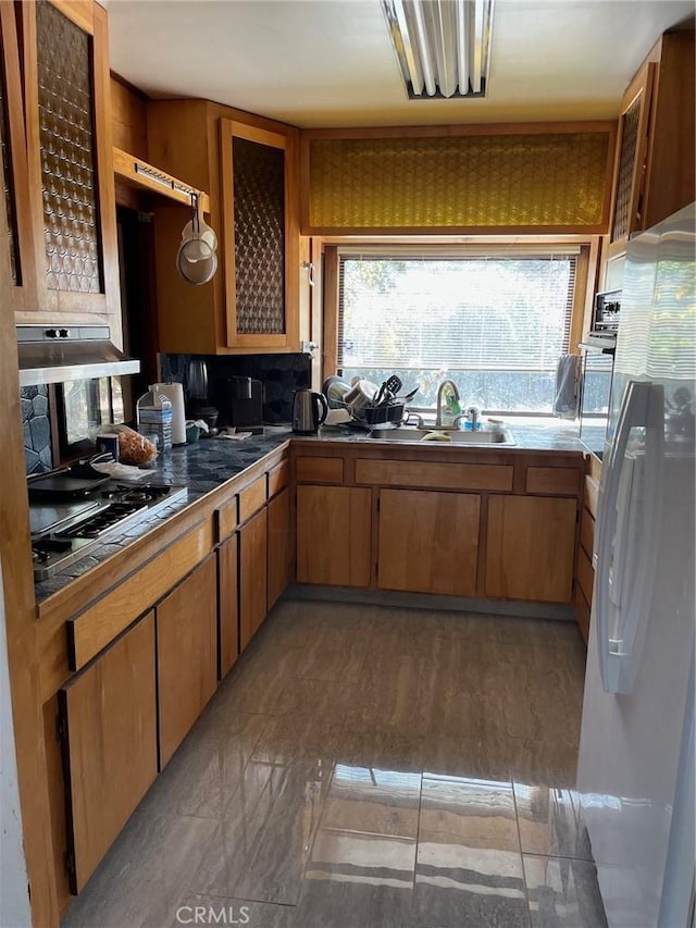 9275 Sheep Ranch Rd, Mountain Ranch, CA 95246 - kitchen featuring white fridge with ice dispenser, a sink, dark countertops, gas cooktop, and stainless steel oven