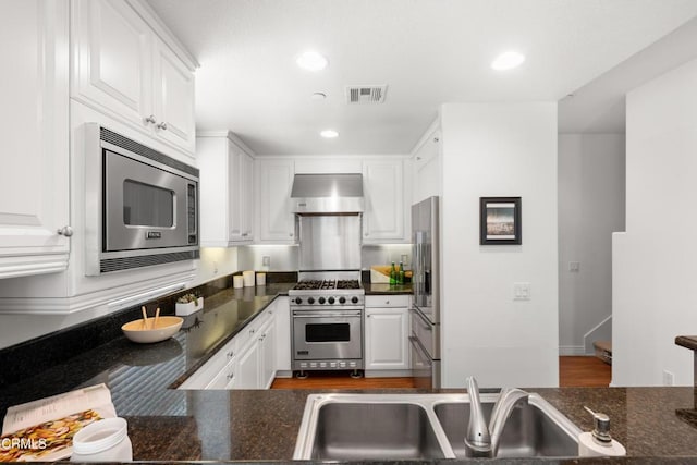 433 N Altadena Dr Unit 4, Pasadena, CA 91107 - kitchen with stainless steel appliances, wall chimney range hood, a sink, white cabinets, and recessed lighting