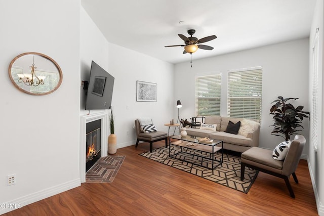 433 N Altadena Dr Unit 4, Pasadena, CA 91107 - living area with wood finished floors, a fireplace, ceiling fan, baseboards, and a chandelier