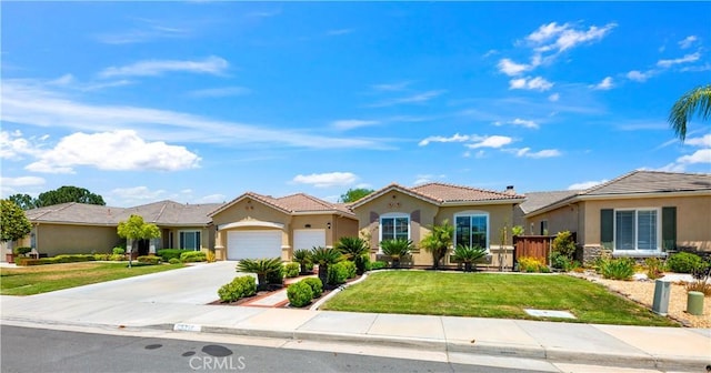 26716 Kingwood Rd, Murrieta, CA 92563 - view of front of home with a garage, stucco siding, a front lawn, and driveway