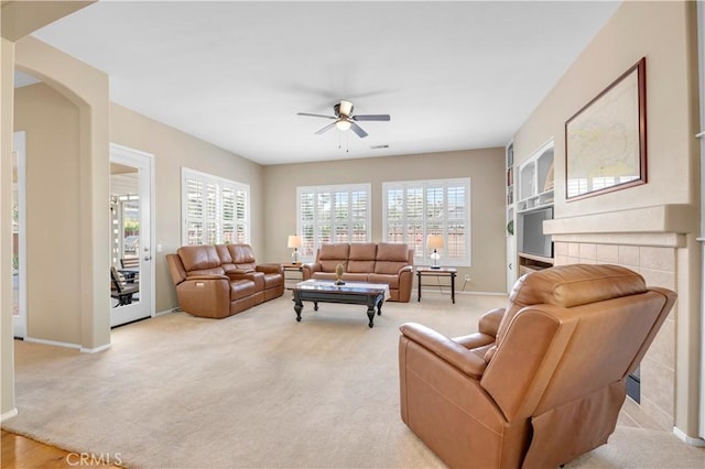 26716 Kingwood Rd, Murrieta, CA 92563 - living area featuring a ceiling fan, light carpet, baseboards, and arched walkways