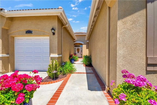 26716 Kingwood Rd, Murrieta, CA 92563 - property entrance featuring stucco siding, a tiled roof, and a garage