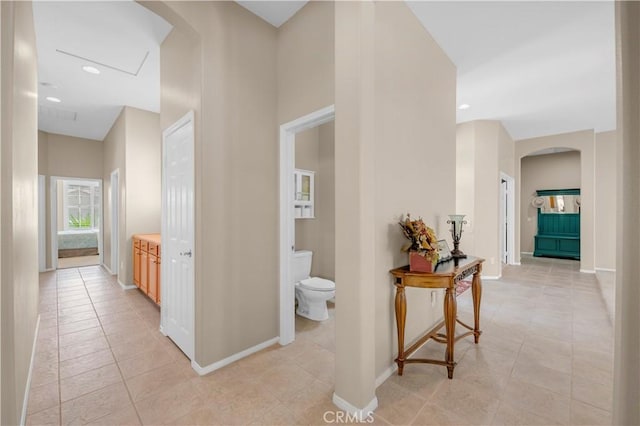 26716 Kingwood Rd, Murrieta, CA 92563 - hall with arched walkways, light tile patterned floors, baseboards, recessed lighting, and a high ceiling