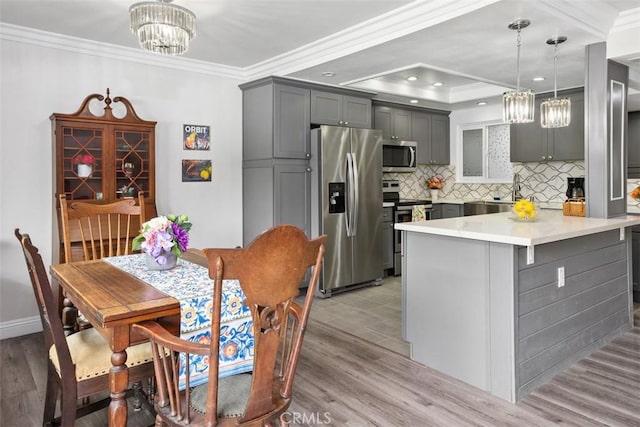 676 Via Alhambra Unit C, Laguna Woods, CA 92637 - kitchen featuring stainless steel appliances, a chandelier, gray cabinetry, crown molding, and light countertops