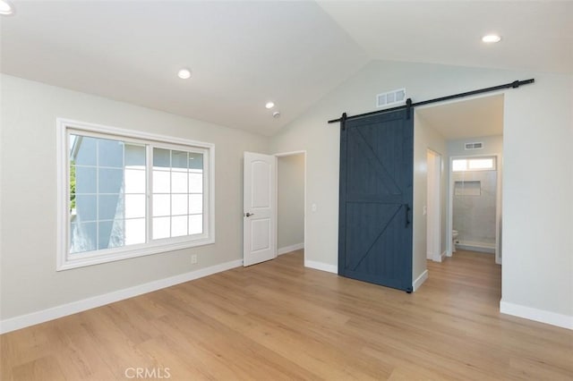 21981 Birchwood, Mission Viejo, CA 92692 - unfurnished bedroom featuring a barn door, vaulted ceiling, light wood-style floors, baseboards, and recessed lighting