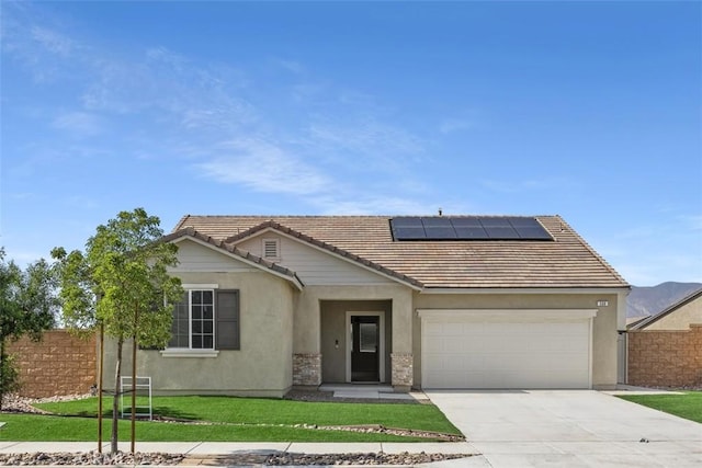 508 Bristolwood Rd, Hemet, CA 92543 - view of front of home featuring a tile roof, stucco siding, roof mounted solar panels, an attached garage, and concrete driveway