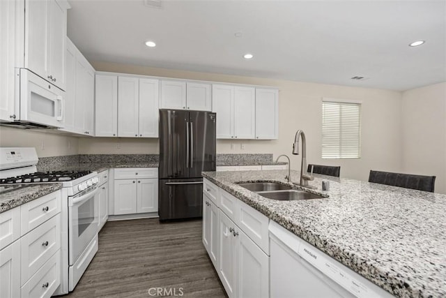 508 Bristolwood Rd, Hemet, CA 92543 - kitchen with white appliances, white cabinets, recessed lighting, dark wood-style flooring, and light stone counters