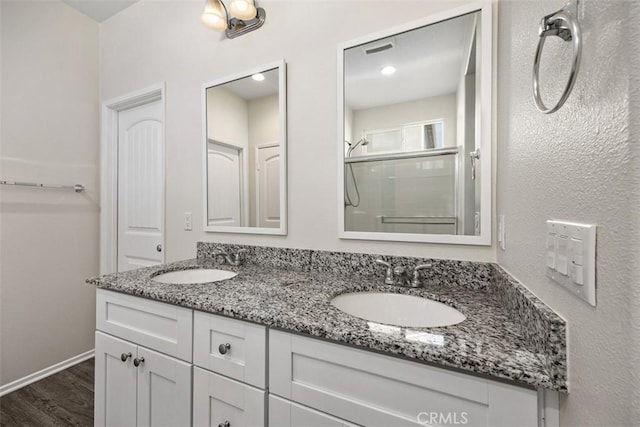 508 Bristolwood Rd, Hemet, CA 92543 - bathroom featuring double vanity, an enclosed shower, and wood finished floors