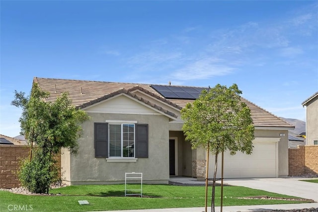 508 Bristolwood Rd, Hemet, CA 92543 - view of front of home with a garage, driveway, roof mounted solar panels, and stucco siding