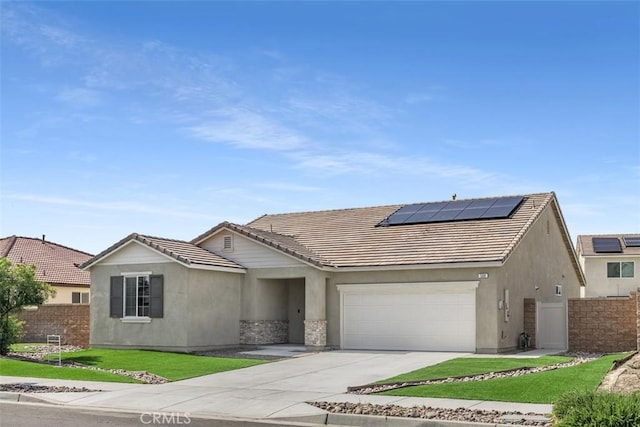 508 Bristolwood Rd, Hemet, CA 92543 - ranch-style home with stucco siding, roof mounted solar panels, concrete driveway, a garage, and a tiled roof