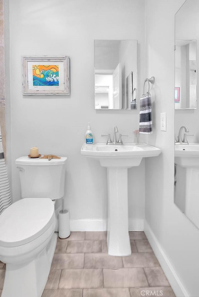 256 Falcon Ave, Long Beach, CA 90802 - bathroom with toilet, baseboards, tile patterned flooring, and a sink