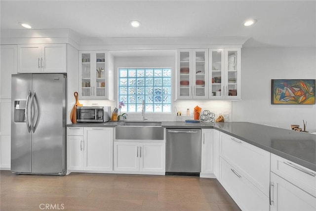 256 Falcon Ave, Long Beach, CA 90802 - kitchen featuring appliances with stainless steel finishes, a sink, white cabinetry, recessed lighting, and glass insert cabinets