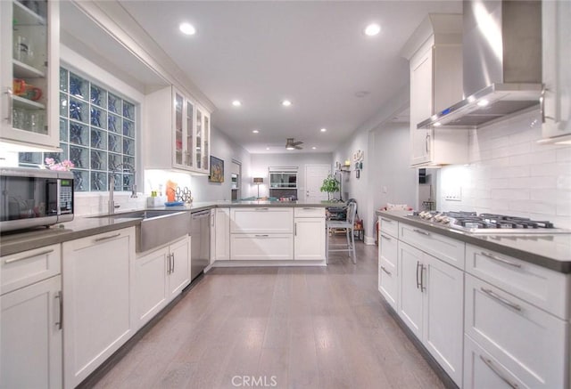 256 Falcon Ave, Long Beach, CA 90802 - kitchen featuring wall chimney exhaust hood, appliances with stainless steel finishes, a peninsula, a ceiling fan, and recessed lighting