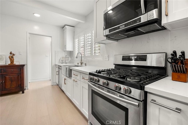 487 N Fern St, Orange, CA 92867 - kitchen with appliances with stainless steel finishes, a sink, tasteful backsplash, white cabinets, and recessed lighting