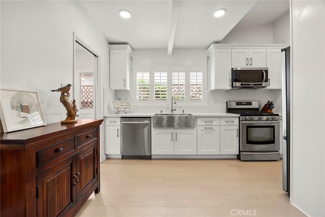 487 N Fern St, Orange, CA 92867 - kitchen featuring stainless steel appliances, a sink, beam ceiling, white cabinetry, and light countertops