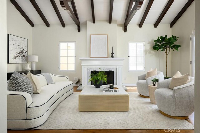 26 Covina Ave, Long Beach, CA 90803 - living area featuring beamed ceiling, healthy amount of natural light, a high end fireplace, and wood finished floors
