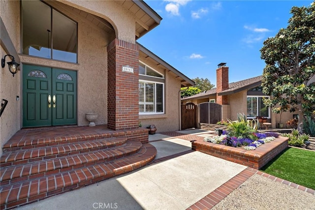 20161 Glacier Cir, Huntington Beach, CA 92646 - doorway to property with stucco siding and a gate