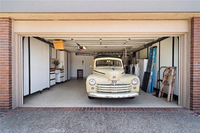 20161 Glacier Cir, Huntington Beach, CA 92646 - garage featuring independent washer and dryer, a garage door opener, and driveway