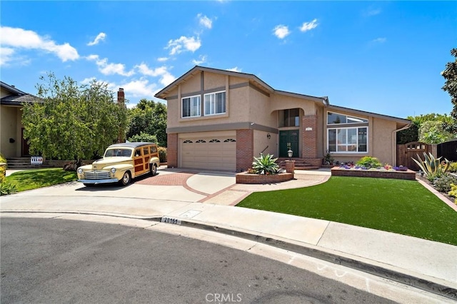 20161 Glacier Cir, Huntington Beach, CA 92646 - view of front of property featuring concrete driveway, an attached garage, stucco siding, and brick siding