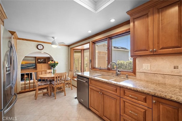 20161 Glacier Cir, Huntington Beach, CA 92646 - kitchen with a sink, stainless steel appliances, ornamental molding, brown cabinets, and recessed lighting