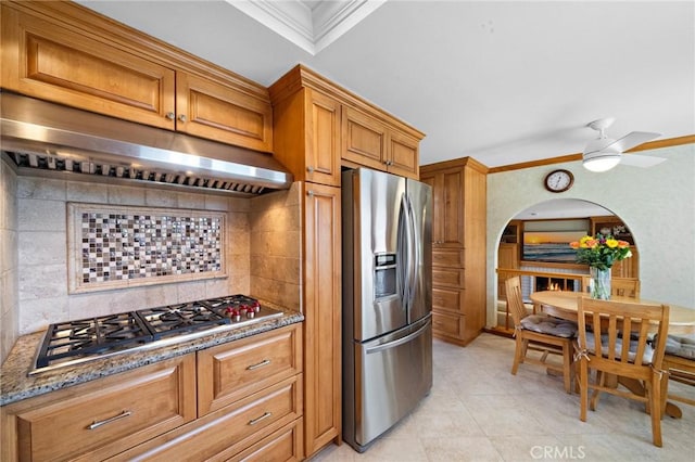 20161 Glacier Cir, Huntington Beach, CA 92646 - kitchen with stainless steel appliances, backsplash, under cabinet range hood, ornamental molding, and brown cabinets