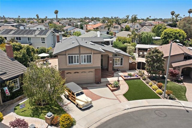 20161 Glacier Cir, Huntington Beach, CA 92646 - view of front facade featuring a residential view, driveway, a garage, and stucco siding