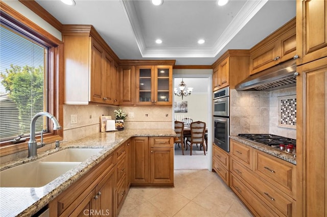 20161 Glacier Cir, Huntington Beach, CA 92646 - kitchen with under cabinet range hood, appliances with stainless steel finishes, a sink, brown cabinets, and recessed lighting