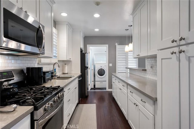 14017 S Wilkie Ave, Gardena, CA 90249 - kitchen featuring stainless steel appliances, washer / clothes dryer, a sink, white cabinetry, and light countertops