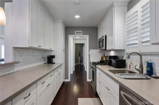 14017 S Wilkie Ave, Gardena, CA 90249 - kitchen featuring stainless steel appliances, a sink, white cabinets, light countertops, and recessed lighting