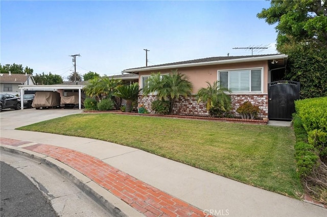 14017 S Wilkie Ave, Gardena, CA 90249 - ranch-style home featuring a front lawn, driveway, brick siding, solar panels, and an attached carport