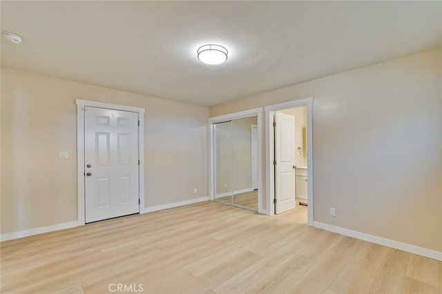 1221 Westminster Ave, East Palo Alto, CA 94303 - unfurnished bedroom featuring light wood-type flooring, baseboards, ensuite bathroom, and a closet