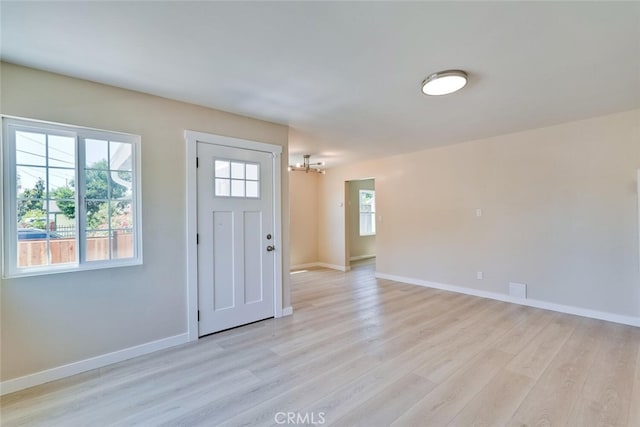 1221 Westminster Ave, East Palo Alto, CA 94303 - foyer with a chandelier, light wood-style flooring, and baseboards
