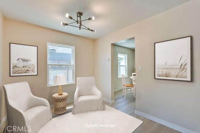 1221 Westminster Ave, East Palo Alto, CA 94303 - living area featuring a chandelier, healthy amount of natural light, wood finished floors, and baseboards