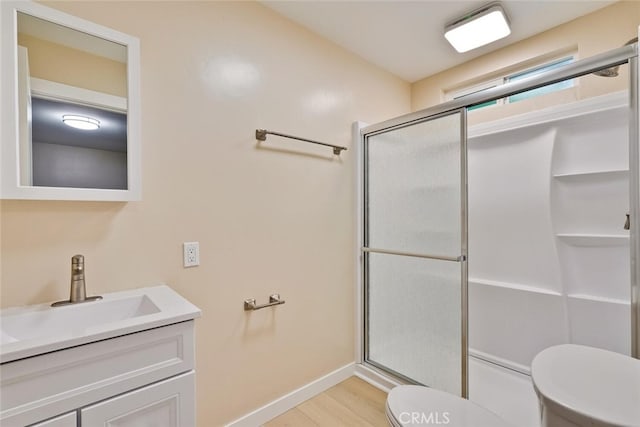 1221 Westminster Ave, East Palo Alto, CA 94303 - full bath featuring toilet, an enclosed shower, vanity, baseboards, and wood finished floors