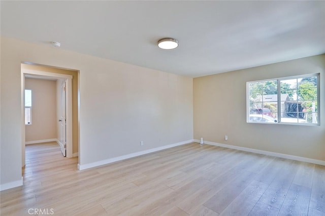 1221 Westminster Ave, East Palo Alto, CA 94303 - empty room with plenty of natural light, light wood finished floors, baseboards, and a smoke detector