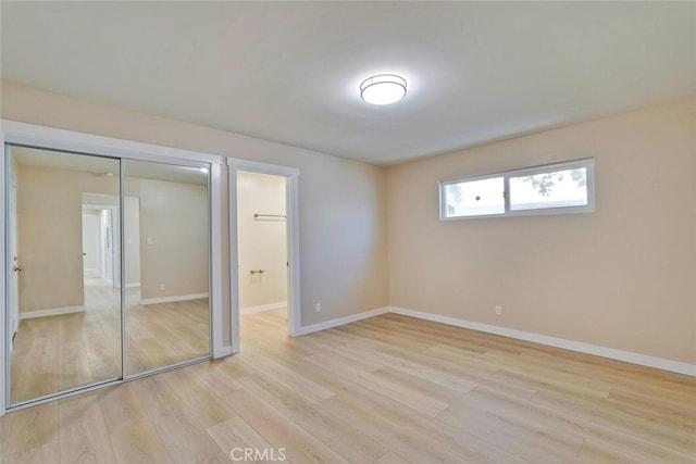 1221 Westminster Ave, East Palo Alto, CA 94303 - unfurnished bedroom featuring light wood-type flooring, baseboards, a closet, and ensuite bath