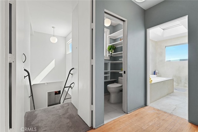 1800 Highland Ave, Manhattan Beach, CA 90266 - full bathroom with toilet, hardwood / wood-style flooring, a bathtub, and a skylight