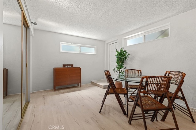 1800 Highland Ave, Manhattan Beach, CA 90266 - dining area featuring light wood-style floors, a textured ceiling, and a textured wall