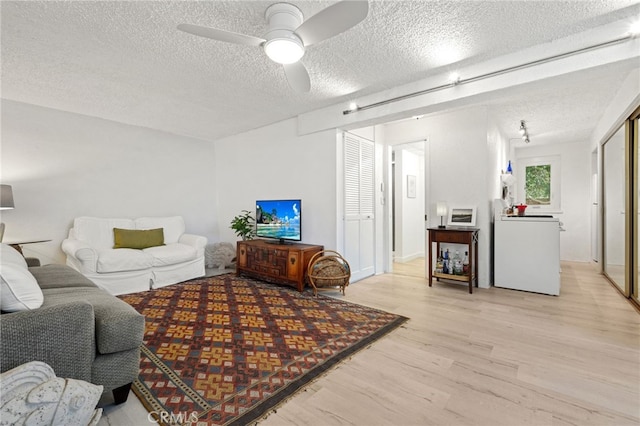 1800 Highland Ave, Manhattan Beach, CA 90266 - living area with light wood-style flooring, a textured ceiling, and a ceiling fan