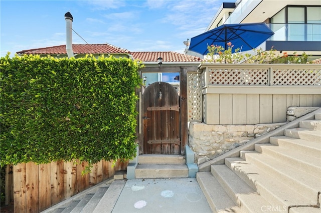1800 Highland Ave, Manhattan Beach, CA 90266 - view of exterior entry with a gate and a tiled roof