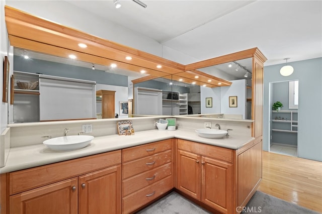 1800 Highland Ave, Manhattan Beach, CA 90266 - bathroom featuring double vanity, wood finished floors, a closet, and track lighting